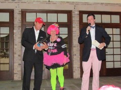 Walsh emcees a past Wiggin' Out Gala and is shown on stage with Teddy Allen and a Wiggin Out supporter.